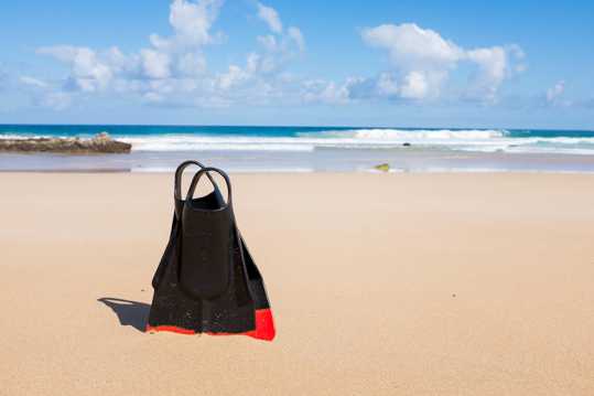 沙滩上的黑色手提袋