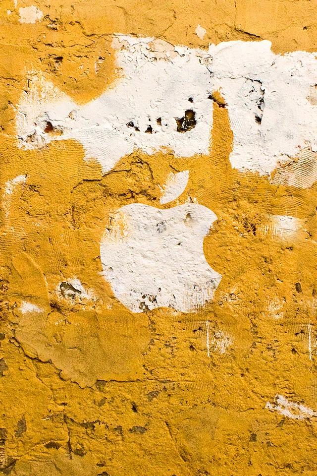 在黄色墙壁iPhone墙纸上的苹果商标